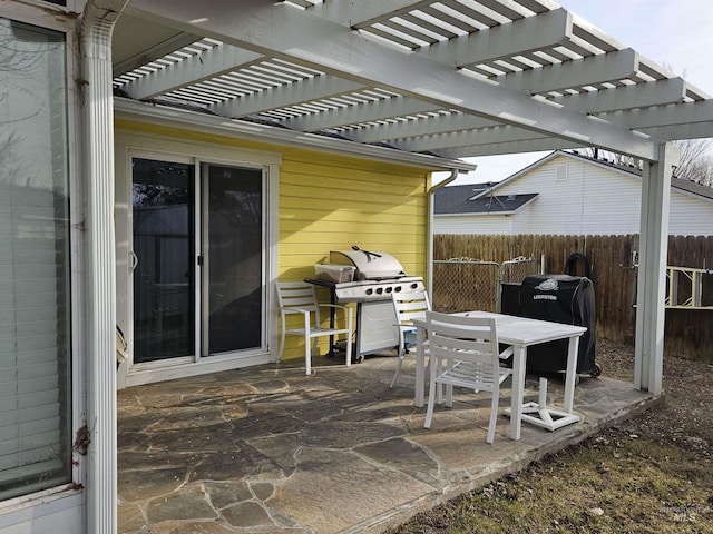 view of patio with area for grilling and a pergola