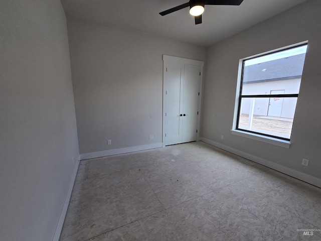 spare room featuring baseboards and ceiling fan