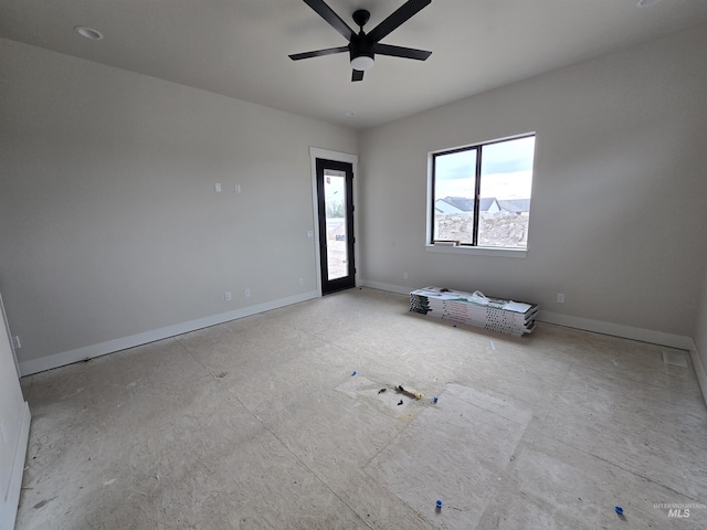 empty room featuring baseboards and ceiling fan