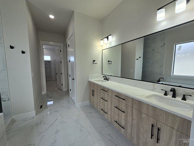 bathroom with healthy amount of natural light, baseboards, and marble finish flooring