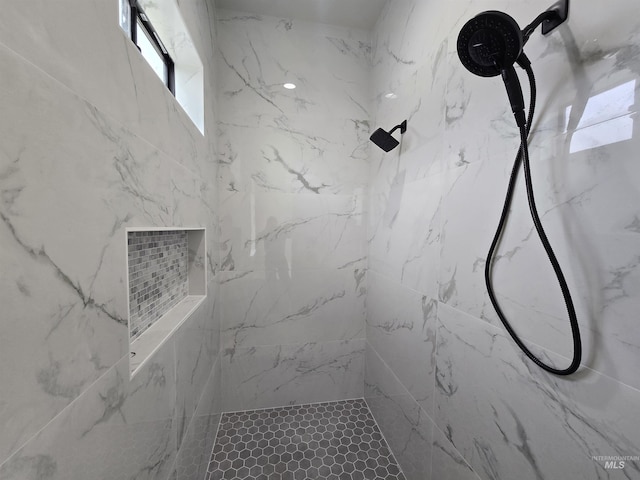 bathroom with a marble finish shower