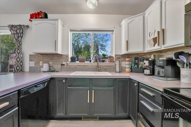 197 Cedarpark Cir, Twin Falls, ID 83301 - kitchen featuring black dishwasher, a sink, white cabinetry, and tasteful backsplash