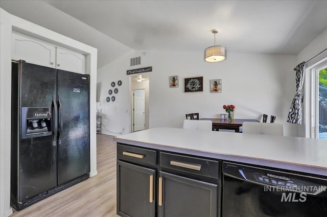 197 Cedarpark Cir, Twin Falls, ID 83301 - kitchen featuring black appliances, white cabinetry, light wood finished floors, hanging light fixtures, and vaulted ceiling