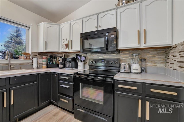 197 Cedarpark Cir, Twin Falls, ID 83301 - kitchen featuring black appliances, a sink, white cabinetry, lofted ceiling, and decorative backsplash