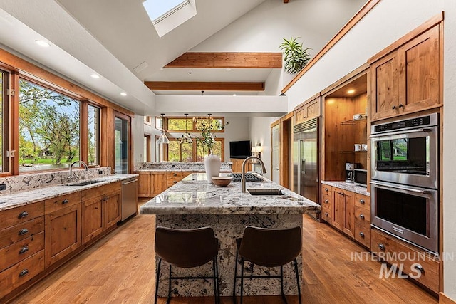 1040 W Bogus Vw, Eagle, ID 83616 - kitchen with brown cabinetry, appliances with stainless steel finishes, and a sink