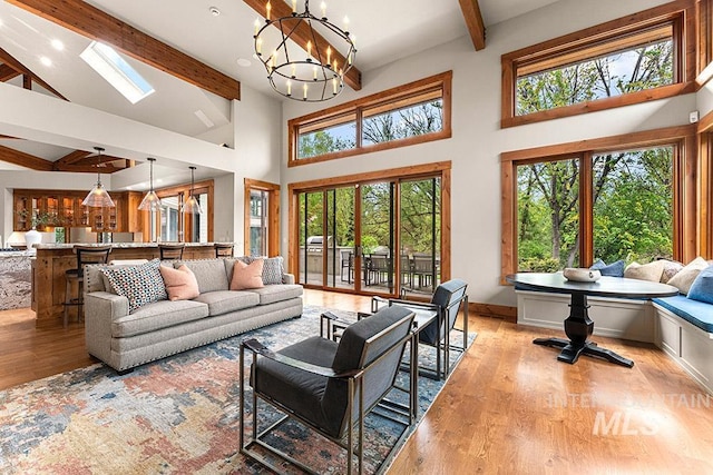 1040 W Bogus Vw, Eagle, ID 83616 - living area with wood finished floors, high vaulted ceiling, recessed lighting, a chandelier, and beamed ceiling