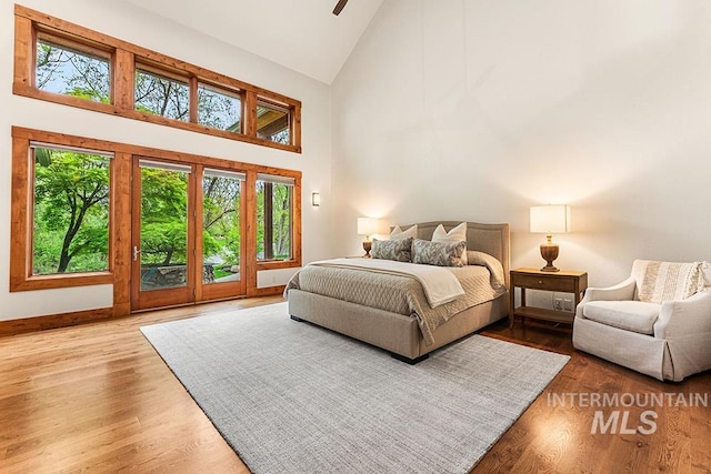 1040 W Bogus Vw, Eagle, ID 83616 - bedroom featuring baseboards, high vaulted ceiling, and wood finished floors
