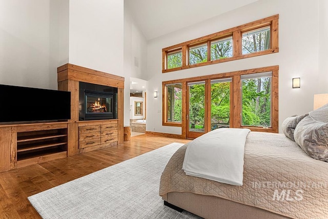 1040 W Bogus Vw, Eagle, ID 83616 - bedroom with multiple windows, wood finished floors, and high vaulted ceiling