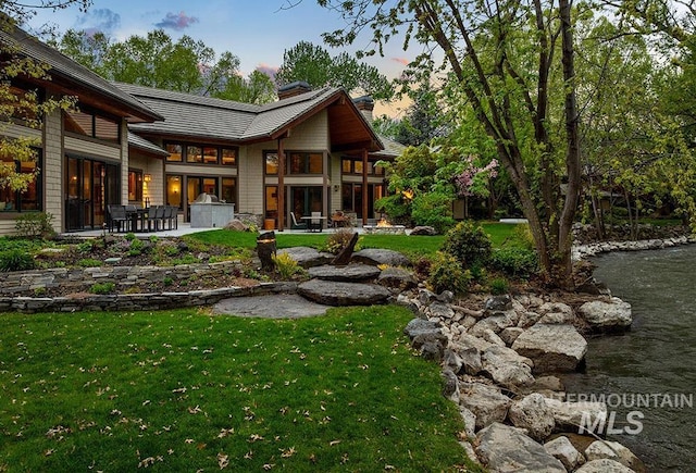 1040 W Bogus Vw, Eagle, ID 83616 - back of house featuring a lawn, a chimney, and a patio