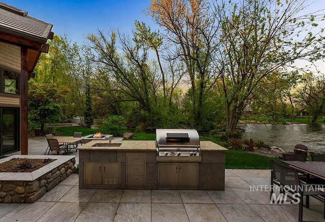 1040 W Bogus Vw, Eagle, ID 83616 - view of patio featuring area for grilling, outdoor dining space, a fire pit, and a sink