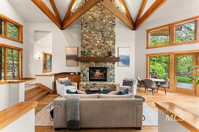 1040 W Bogus Vw, Eagle, ID 83616 - living area featuring a stone fireplace, beam ceiling, high vaulted ceiling, and wood finished floors