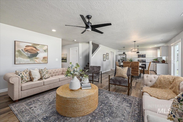 4849 N Willowside Ave, Meridian, ID 83646 - living area with dark wood-style floors, a ceiling fan, a textured ceiling, stairs, and baseboards