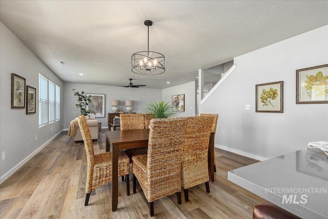 4849 N Willowside Ave, Meridian, ID 83646 - dining space with a chandelier, light wood-type flooring, baseboards, a textured ceiling, and ceiling fan