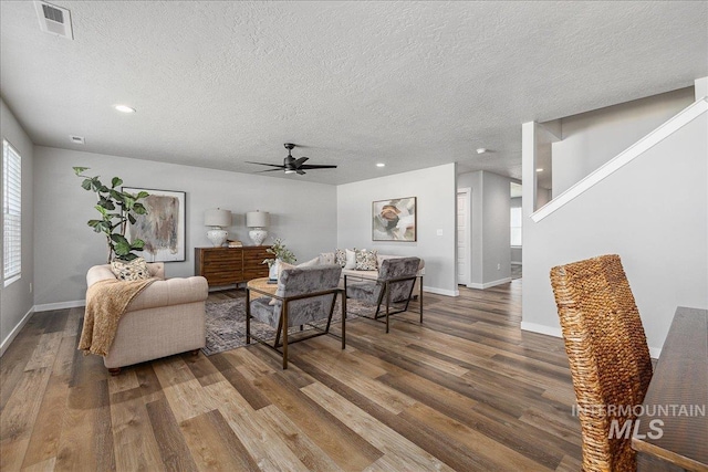 4849 N Willowside Ave, Meridian, ID 83646 - living room featuring wood finished floors, ceiling fan, a textured ceiling, recessed lighting, and baseboards
