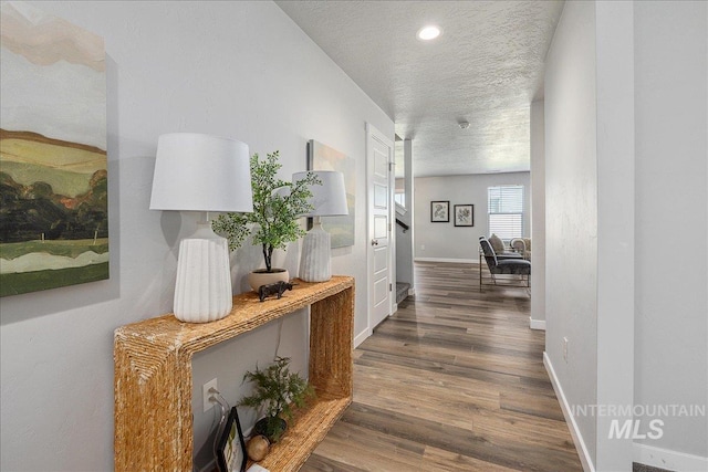 4849 N Willowside Ave, Meridian, ID 83646 - hallway featuring a textured ceiling, dark wood-type flooring, and baseboards