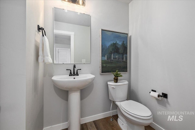 4849 N Willowside Ave, Meridian, ID 83646 - bathroom featuring toilet, wood finished floors, and baseboards