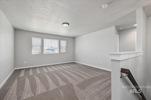 4849 N Willowside Ave, Meridian, ID 83646 - carpeted spare room with a smoke detector, baseboards, and a textured ceiling