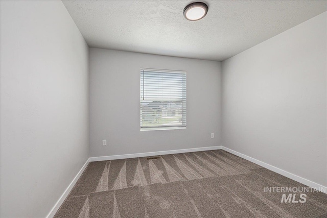 4849 N Willowside Ave, Meridian, ID 83646 - empty room with carpet floors, a textured ceiling, and baseboards