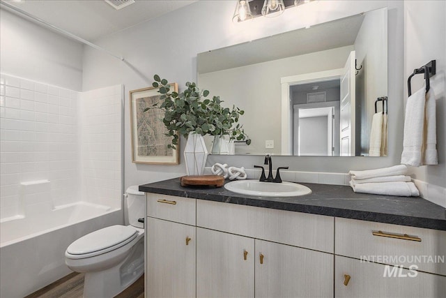 4849 N Willowside Ave, Meridian, ID 83646 - full bathroom with vanity, toilet, washtub / shower combination, and wood finished floors