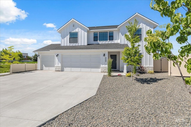 4849 N Willowside Ave, Meridian, ID 83646 - view of front of house with board and batten siding, concrete driveway, stone siding, and an attached garage
