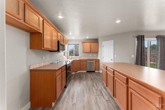 5291 N Midnight Haze Way, Meridian, ID 83646 - kitchen with appliances with stainless steel finishes, light wood-style floors, recessed lighting, light countertops, and brown cabinetry