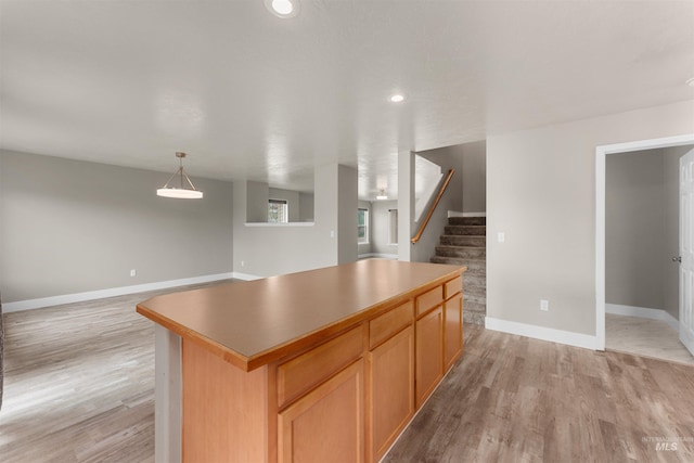 5291 N Midnight Haze Way, Meridian, ID 83646 - kitchen with light wood-type flooring, a kitchen island, recessed lighting, open floor plan, and decorative light fixtures