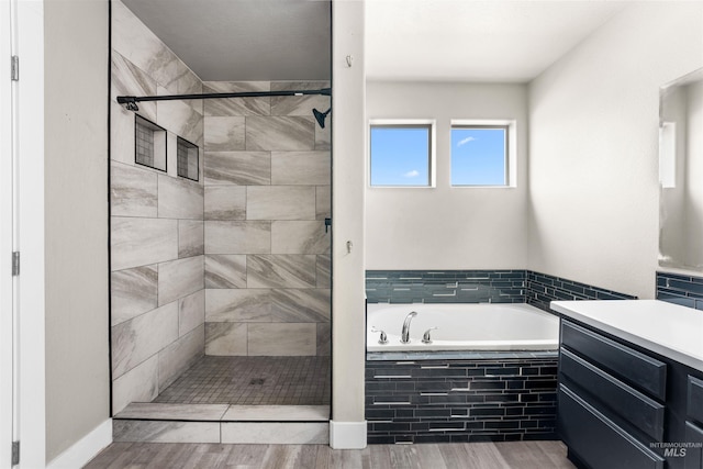 5291 N Midnight Haze Way, Meridian, ID 83646 - full bath featuring a garden tub, a stall shower, vanity, and wood finished floors