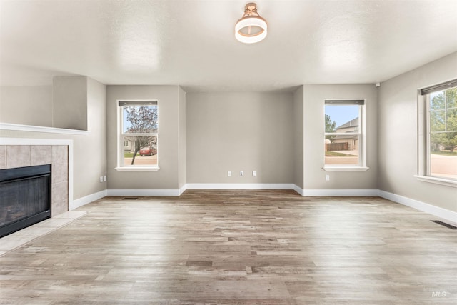 5291 N Midnight Haze Way, Meridian, ID 83646 - unfurnished living room with wood finished floors and a fireplace