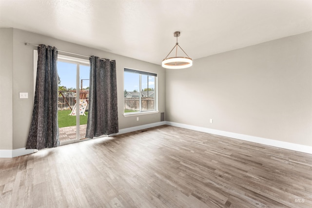 5291 N Midnight Haze Way, Meridian, ID 83646 - unfurnished room featuring wood finished floors and baseboards