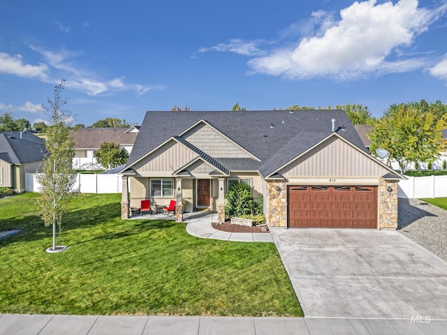 812 Kelli Ln, Filer, ID 83328 - craftsman house featuring board and batten siding, a front yard, fence, an attached garage, and concrete driveway