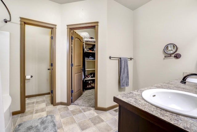 812 Kelli Ln, Filer, ID 83328 - full bath with a sink, baseboards, a walk in closet, and a shower