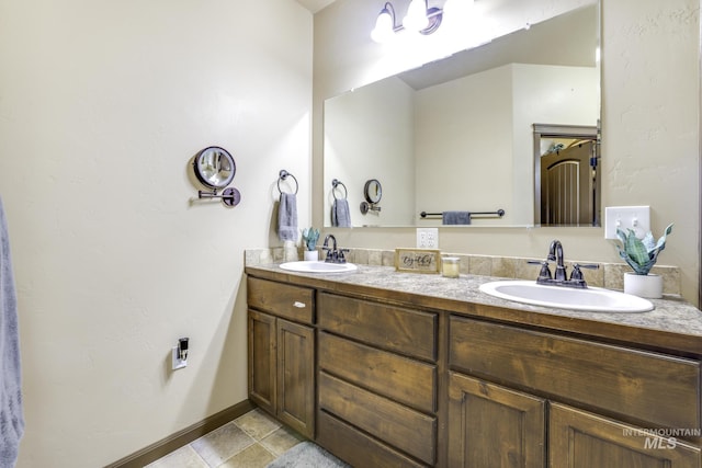 812 Kelli Ln, Filer, ID 83328 - bathroom featuring double vanity, a sink, and baseboards