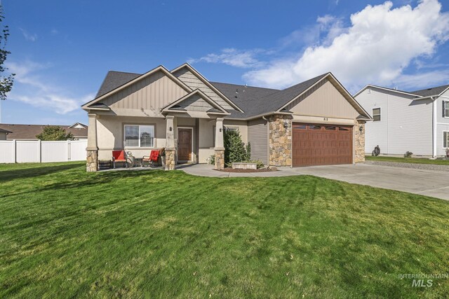 812 Kelli Ln, Filer, ID 83328 - craftsman-style home with a garage, a front yard, stone siding, fence, and concrete driveway