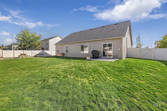 812 Kelli Ln, Filer, ID 83328 - rear view of house with a fenced backyard, a lawn, a patio, a gate, and a shingled roof