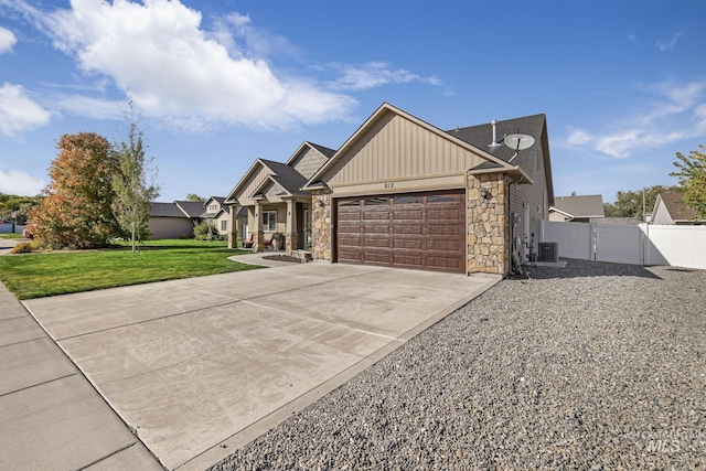 812 Kelli Ln, Filer, ID 83328 - view of front of house featuring board and batten siding, central AC, a front lawn, a garage, and concrete driveway