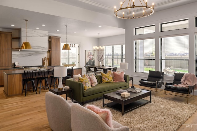 living room with light wood-type flooring and a chandelier