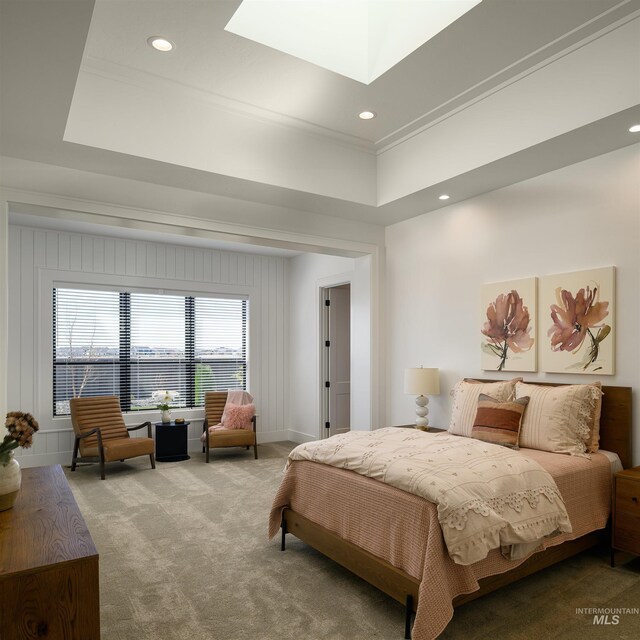 carpeted bedroom featuring a raised ceiling