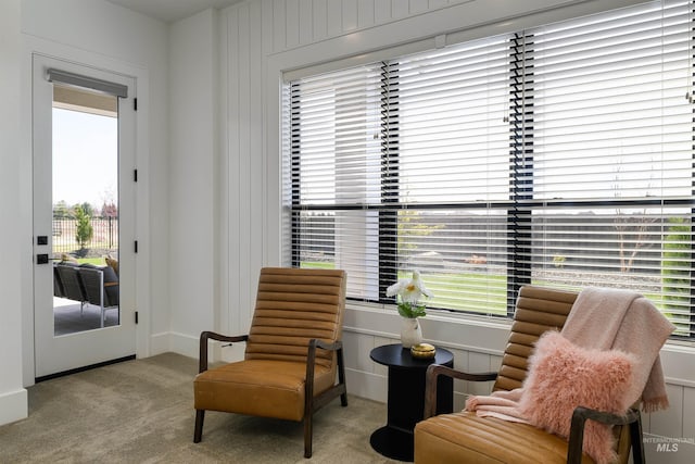 sitting room featuring light colored carpet