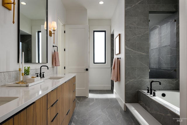 bathroom featuring shower with separate bathtub, dual bowl vanity, and tile floors