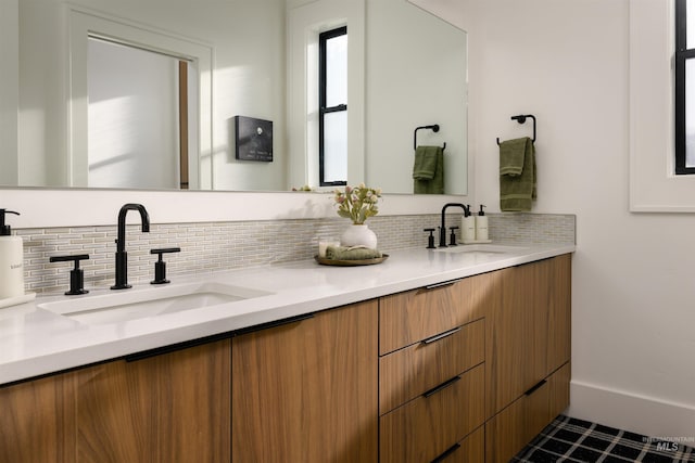 bathroom featuring tile flooring, tasteful backsplash, and double vanity