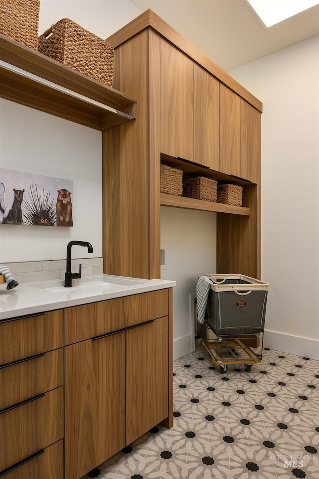 kitchen featuring light tile floors and sink