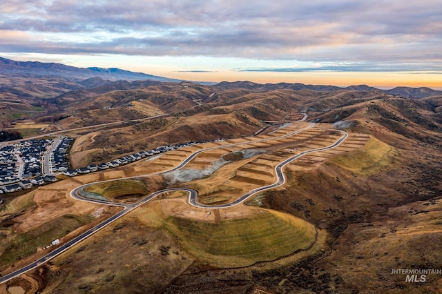 aerial view at dusk featuring a mountain view