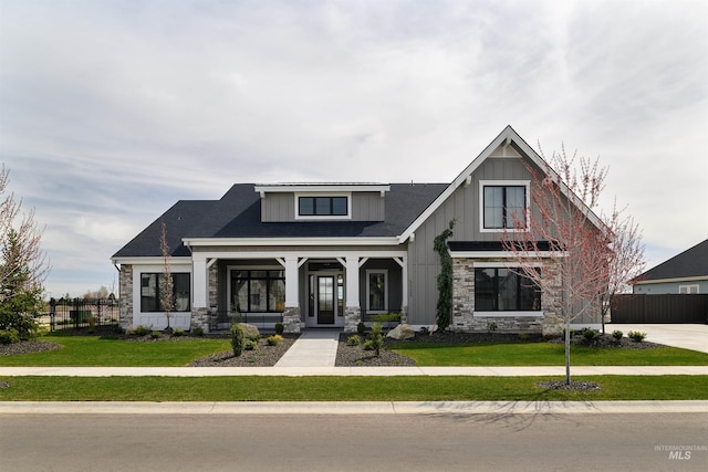 craftsman-style house with covered porch and a front lawn