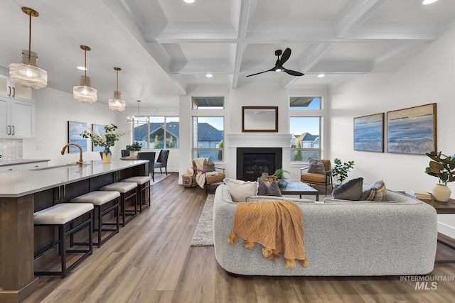 2477 E Galleon Ln, Meridian, ID 83642 - living area featuring plenty of natural light, beam ceiling, ceiling fan, wood finished floors, and coffered ceiling
