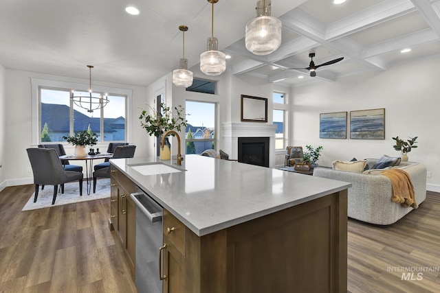2477 E Galleon Ln, Meridian, ID 83642 - kitchen with stainless steel dishwasher, a sink, dark wood-style flooring, plenty of natural light, and beamed ceiling