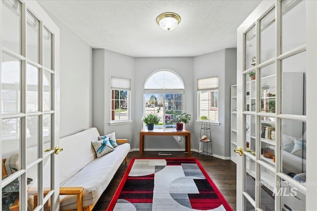 2668 N Morello, Meridian, ID 83646 - sitting room with french doors, baseboards, wood finished floors, and a textured ceiling