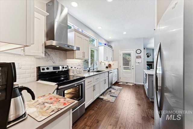 2668 N Morello, Meridian, ID 83646 - kitchen featuring wall chimney range hood, light countertops, white cabinetry, appliances with stainless steel finishes, and a sink