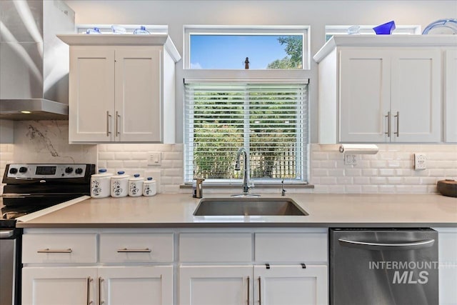2668 N Morello, Meridian, ID 83646 - kitchen featuring wall chimney exhaust hood, tasteful backsplash, white cabinets, appliances with stainless steel finishes, and a sink