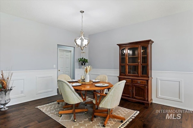 2668 N Morello, Meridian, ID 83646 - dining area with dark wood-type flooring, a wainscoted wall, and a notable chandelier