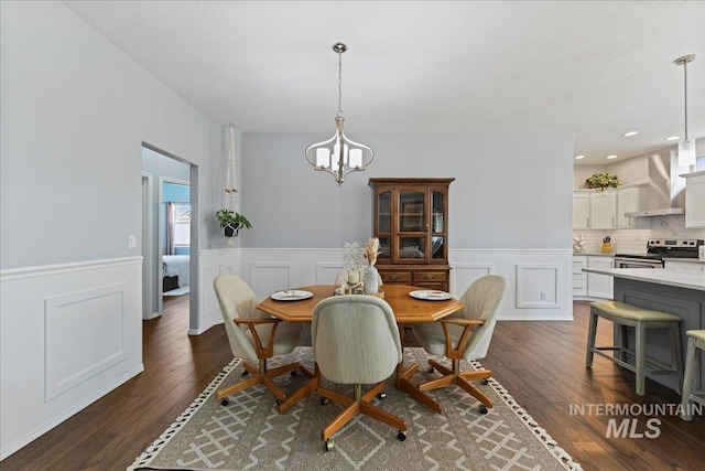 2668 N Morello, Meridian, ID 83646 - dining space featuring a wainscoted wall, an inviting chandelier, and dark wood-style floors